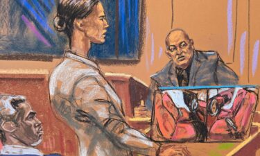 Sean "Diddy" Combs watches as prosecutor Christy Slavik questions Los Angeles fire arson investigator Lance Jimenez near a photo of the interior of Scott Mescudi's damaged car.